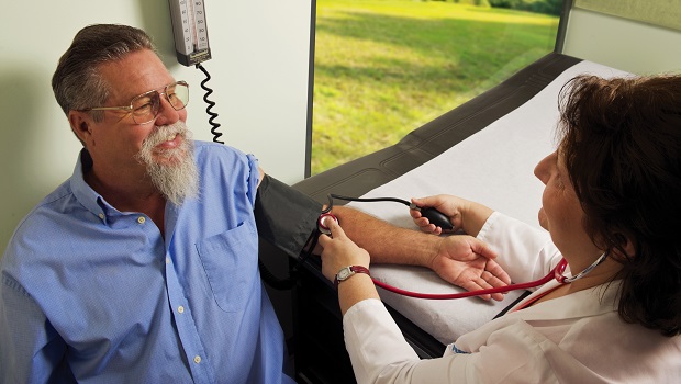 Photograph of a man getting his blood pressure checked